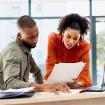 Document, business and people in office with advice, planning or review of resume for hiring. Application, portfolio and human resources team with paper for question, decision or career assessment.
